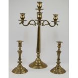 A brass five light candelabra, with four scrolling branches issuing from the central stem, 57cm h...