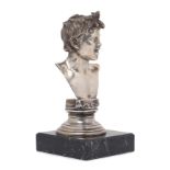 A cast white metal bust of a smiling boy, after Gemito, stamped 800, the cast bust raised on a st...