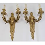 A pair of French Empire style gilt metal twin light wall appliques, 19th century, modelled as car...