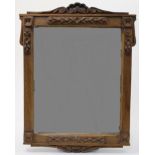 An Arts & Crafts style oak mirror, early 20th century, with scroll shell cresting and foliate car...