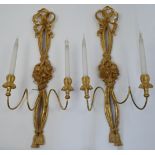 A pair of modern gilt-wood twin-light wall appliques, each with ribbon-tied and tassel backplate ...