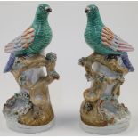 A pair of Victorian Staffordshire models of exotic birds, each perching on a brocade with tree br...