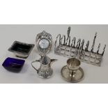 A group of silver, comprising: a pair of four division toast racks, Sheffield, 1933, Atkin Brothe...