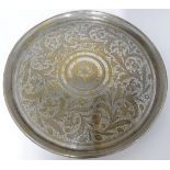 A South Indian silvered brass circular concave tray, 19th century, decorated with scrolling folia...