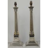 A pair of silver plated Corinthian column table lamps, on square stepped bases, approx. 49cm high...