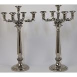 A pair of plated five light candelabra, each with foliate branches on column support and circular...