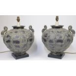 A pair of metal globular urn shaped table lamps, 20th century, with twin handles modelled as drag...