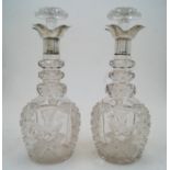 A pair of cut glass decanters and stoppers with silver collars, Sheffield, 1924, probably Walker ...