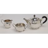 A silver three piece tea service by Mappin & Webb, Birmingham, 1938, comprising a teapot with ebo...