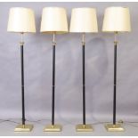 A set of four brass and black lacquered standard lamps, late 20th century, with Corinthian capita...