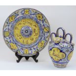 A Spanish Talavera tin-glazed earthenware charger and pot, late 19th century, each painted in blu...