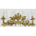 An French rococo ormolu four branch wall light, 19th century, the stems issuing from a scrolling ...