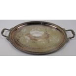 A silver plated twin handled tray, of oval form with chased scrolling foliate decoration within b...