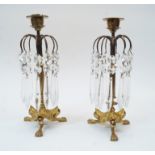 A pair of Regency style brass candlestick lustres with facetted glass drops, first half 20th cent...