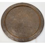 A large Islamic bronze dish, 20th century, decorated with elaborate floral and calligraphic desig...