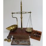 A set of brass weighing scales by W. & T. Avery, late 19th / early 20th century, with a set of th...