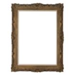 A carved and gilded reverse glazed frame, mid 20th century- with cavetto sight, schematic leaf an...