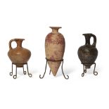 Two Egyptian Middle Kingdom pottery vessels, including an ovoid alabastron tapering to a point, w...