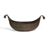 An engraved copper kashkul, Armenia, 19th century, of shallow form, with dragon head terminals, t...