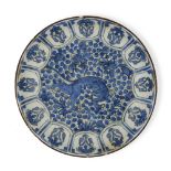 A Safavid blue and white pottery dish depicting a lion, Persia, 17th century, the stonepaste body...
