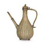 An engraved brass fluted ewer, possibly Lahore, North India, first half 18th century, rising on f...