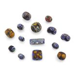 A collection of Roman spherical glass ‘eye’ beads with dark and light blue with white, and later ...