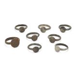 Eight Medieval bronze rings, each with an engraved circular bezel, some with Christian inscriptio...