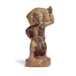 A Greek terracotta figure of a nude phallic dwarf, carrying a sack across his back, set on an int...