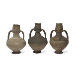 Three unglazed vessels, probably Eastern Persia or Syria, 10th-12th century,  each of baluster fo...