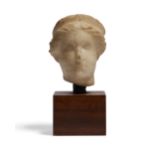 A small Roman marble female head, wearing a diadem, circa 2nd Century A.D., 4.8cm high, mounted ...