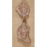 Two Greek terracotta hollow-backed relief fragments, each of a bearded male banqueteer wearing ta...