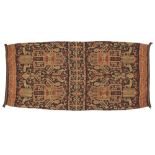 A cotton textile, Indonesia, 20th century, of rectangular form, woven in shades of red, brown and...