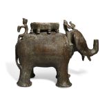 A large engraved bronze elephant, India, late 18th century, shown standing with a howdah, a figur...