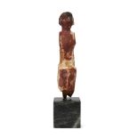 An Egyptian Middle Kingdom wood seated male figure with much of the original pigment remaining, a...