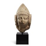 An Iberian carved limestone head of a female, 5th-1st century B.C., with Hellenistic-style face, ...