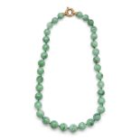 A Chinese apple-green jadeite bead necklace Republic period Comprising thirty-five beads mounte...