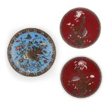 Three Japanese cloisonné-enamel 'kacho-ga' plates Meiji period Comprising: a pair of red-ground...