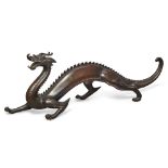 A large Japanese bronze dragon okimono by the Sekiya Company Meiji period Cast with arched back...