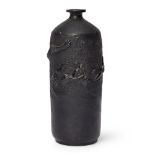 A Japanese black Tokoname ware sake bottle Meiji Period Moulded to the body with a dragon emerg...