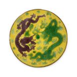 A Chinese aubergine and green-enamelled yellow-ground 'dragons' circular fragment Qing Dynasty, ...
