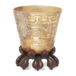 A Chinese mottled creamy and mushroom jade archaistic cup Ming dynasty  The tapering shape thin...