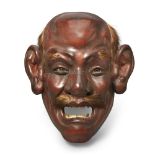 A Japanese papier-mâché painted lacquer mask Meiji period With painted glass eyes, open mouth a...