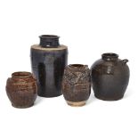 Four large Chinese and Sawankhalok black-glazed vessels 15th-16th century Comprising a large ja...