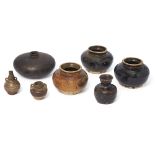 Seven Chinese and Sawankhalok vessels 15th-16th century Comprising three squat black-glazed vas...