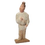 A Chinese pottery figure of a courtier Tang dynasty Modelled standing, with painted facial feat...