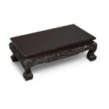 A Chinese carved hardwood rectangular stand Early 20th century The waisted stand rising from fo...