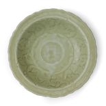 A Chinese Longquan celadon foliate dish Ming dynasty Standing on short straight foot rising to ...