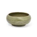 A Chinese Yaozhou-style celadon-glazed shallow bowl 20th century Carved to the centre with twin...