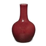 A Chinese red-glazed bottle vase Qing dynasty, 19th century The globular form sweeping up to a ...