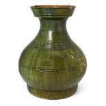 A large Chinese green-glazed jar, hu Han dynasty With flat base raised on three rectangular tri...